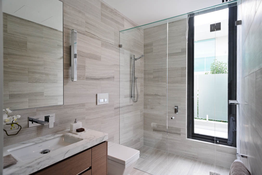 Frameless shower screen in tiled bathroom